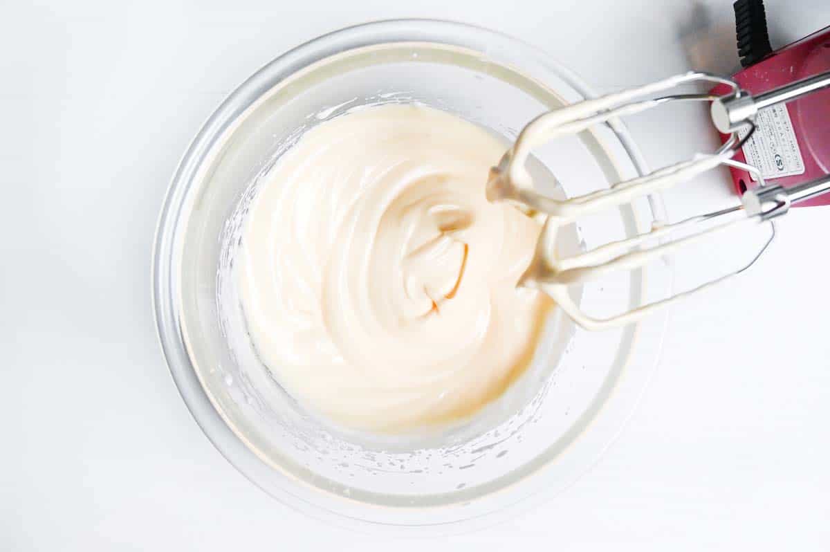 Whipped egg whites and yolks in a glass bowl