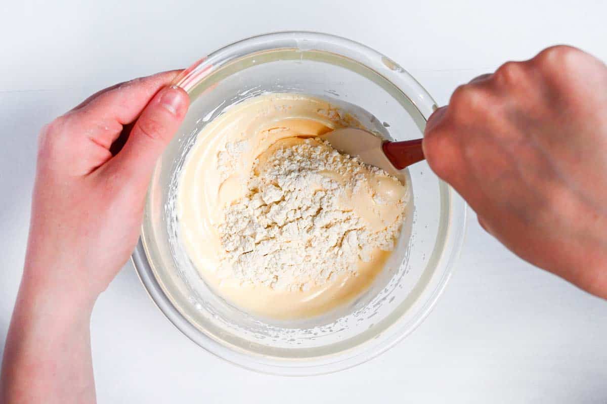 Folding sifted flour into whipped eggs