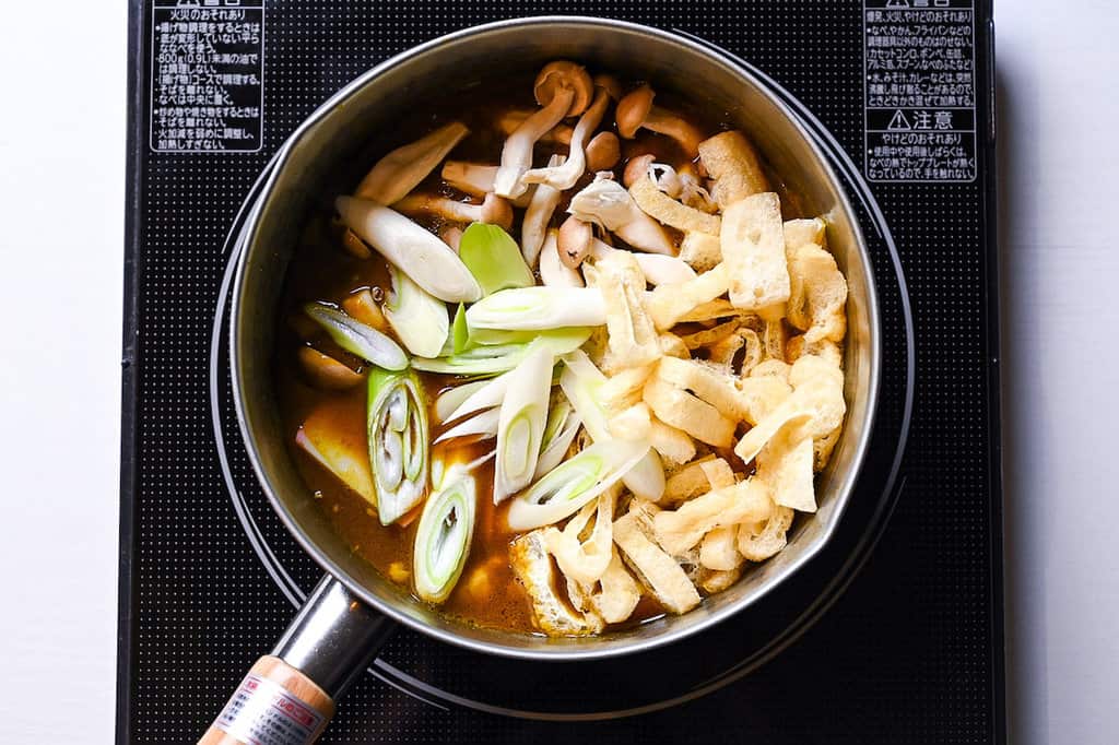 adding the ingredients to the pot