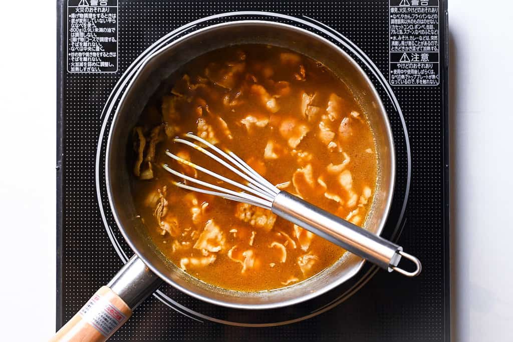 mixing in the curry paste