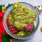 Matcha christmas tree cookies stacked in a glass jar