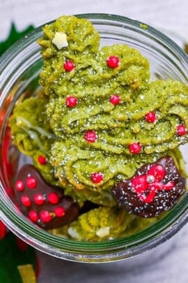 Matcha christmas tree cookies stacked in a glass jar
