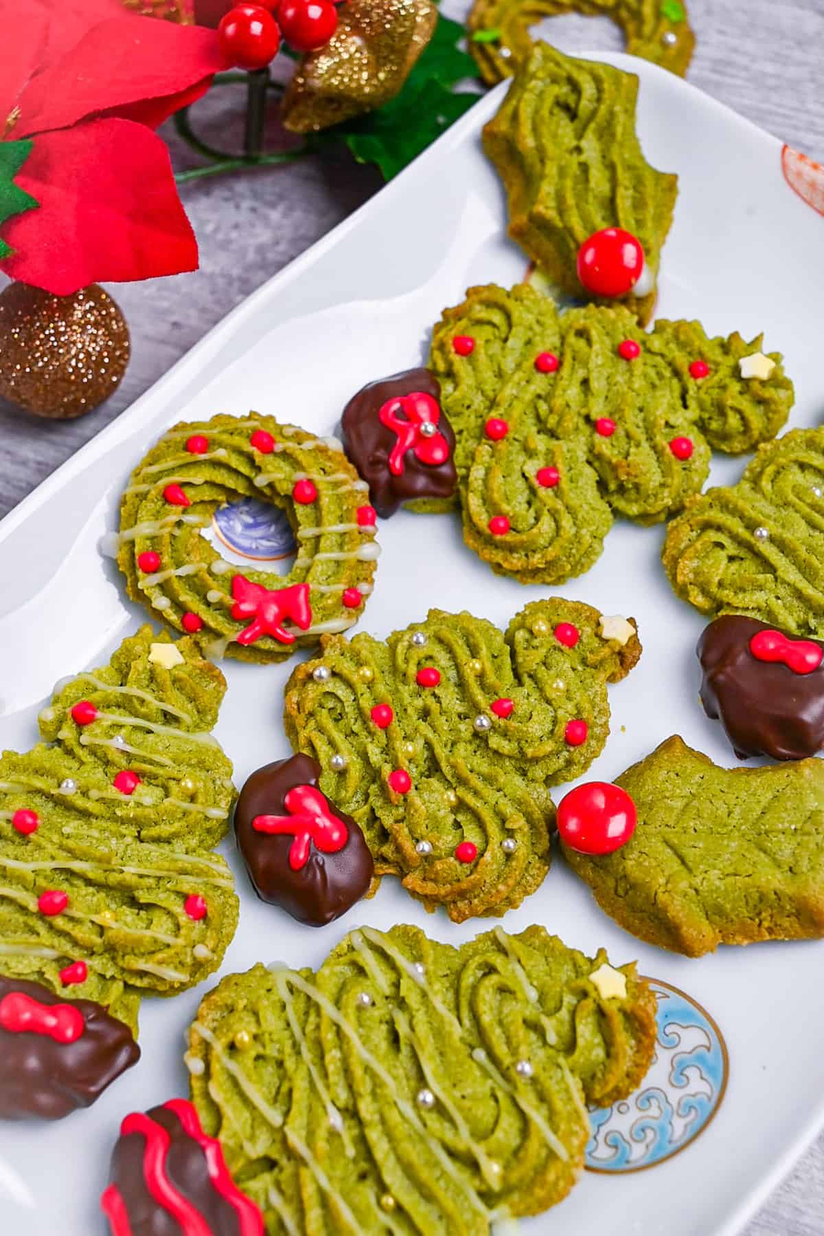 Matcha green tea christmas cookies on a white rectangular plate