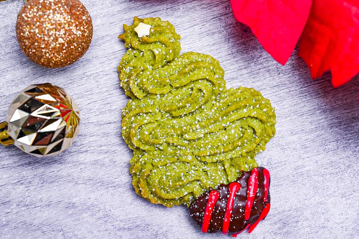 Matcha green tea christmas tree cookie on a gray wood effect background