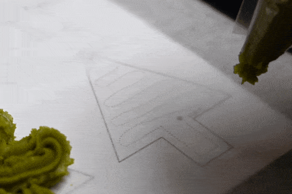 Animated gif showing how to pipe a matcha christmas tree cookie