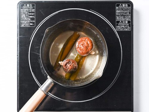 Kombu and shiitake dashi in a pan on the stove