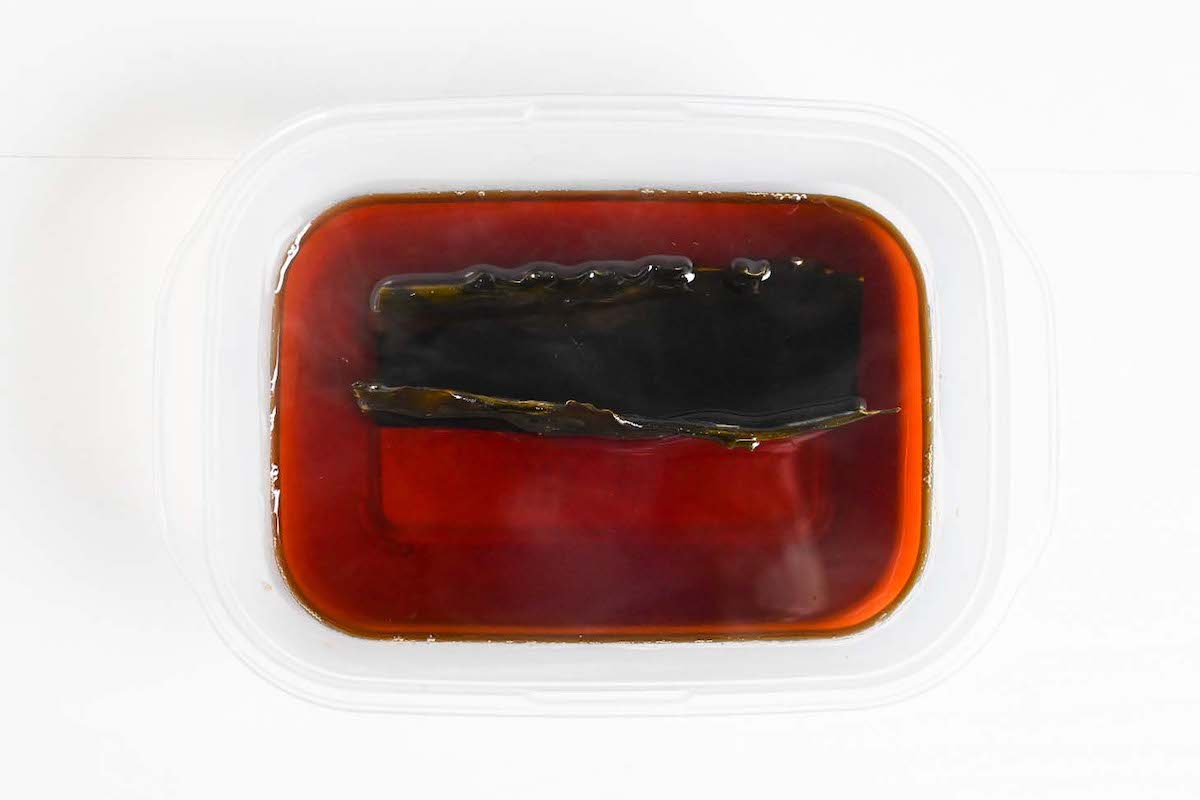 Sukiyaki warishita sauce in a container with kombu