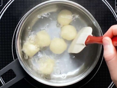 gently mixing the dango to stop them sticking to the bottom of the pot