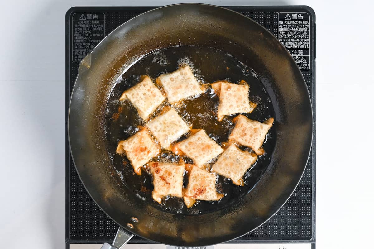 deep frying curry age gyoza in a wok