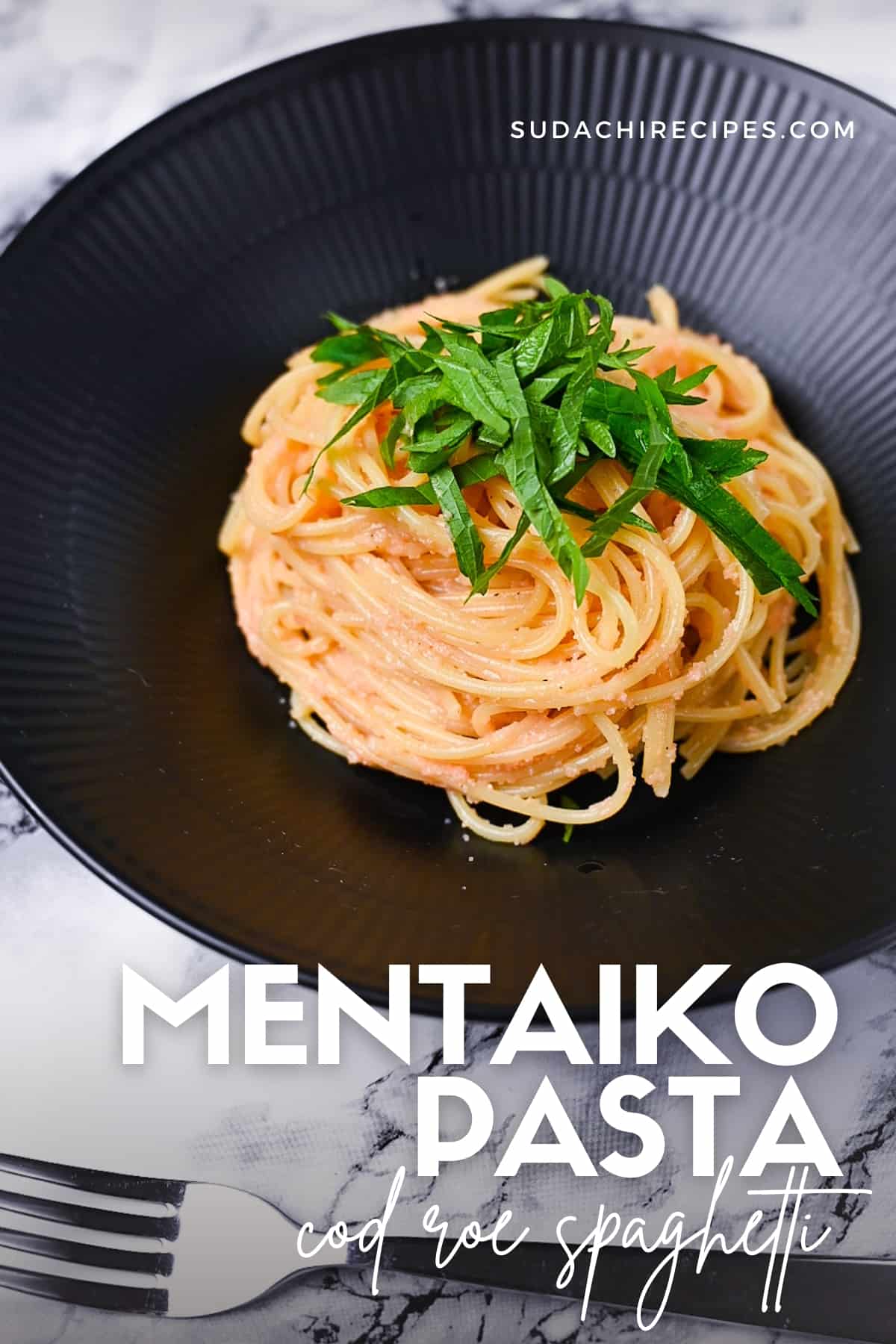 Mentaiko pasta (cod roe spaghetti) in a black pasta dish topped with shredded shiso (Perilla) leaves