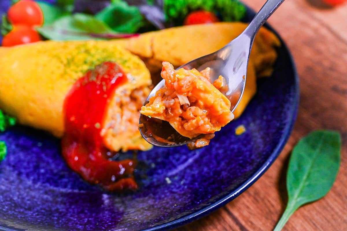 Omurice (Japanese omelette rice) on a silver spoon