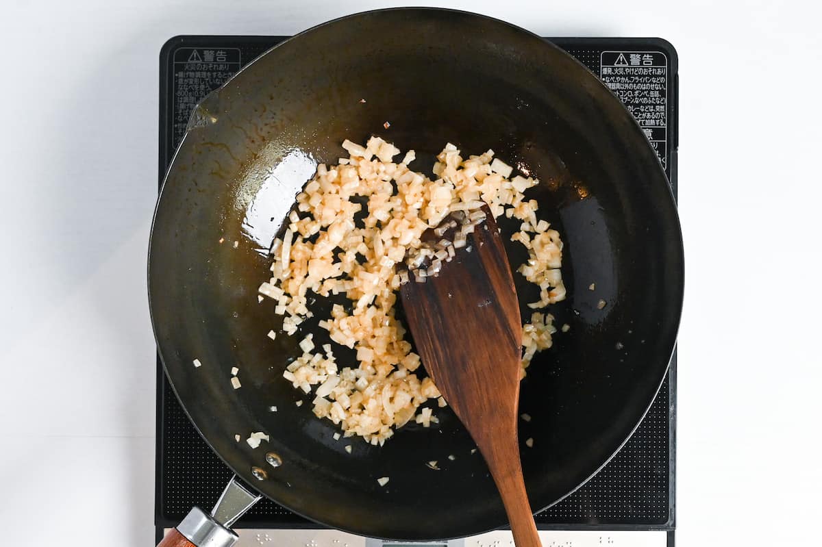 frying finely diced onions in a wokwith olive oil and butter
