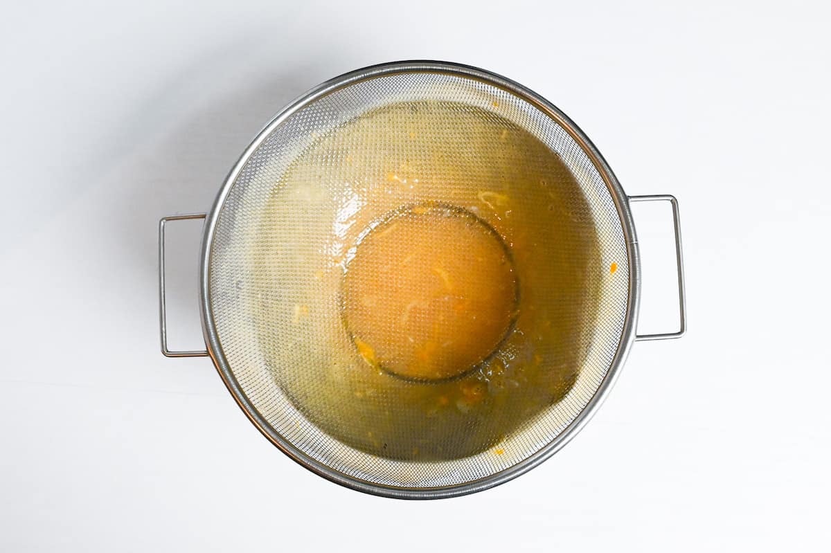 whisked egg poured through a fine mesh sieve