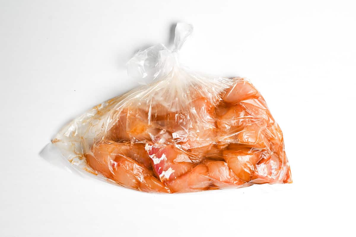 marinating pieces of cod in a plastic bag