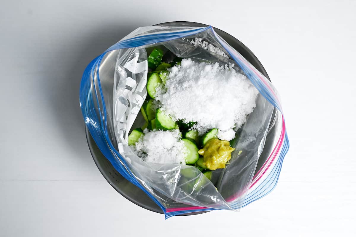 Roughly chopped Japanese cucumbers in a ziplock bag with salt, sugar and wasabi paste.