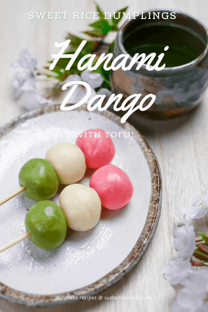 hanami dango on a plate with cherry blossoms and a cup of green tea