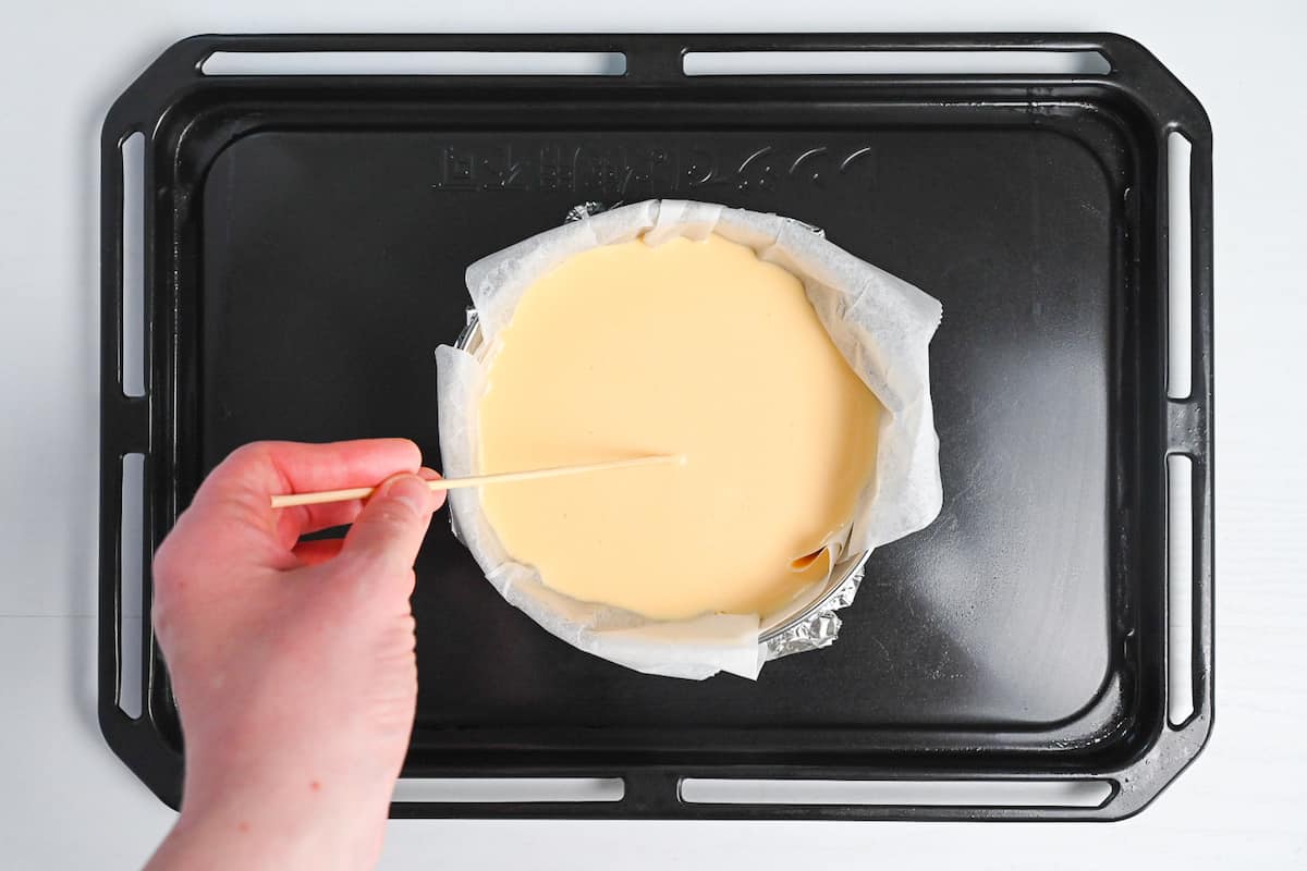 Removing air bubbles from surface of basque-style cheesecake