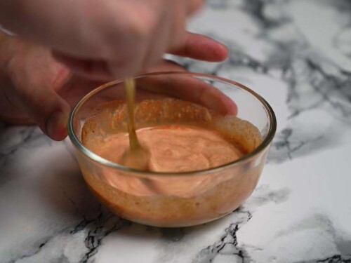 Mixing ebi mayo sauce in a small glass bowl