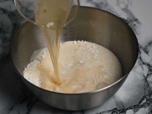 adding beer to the chilled batter