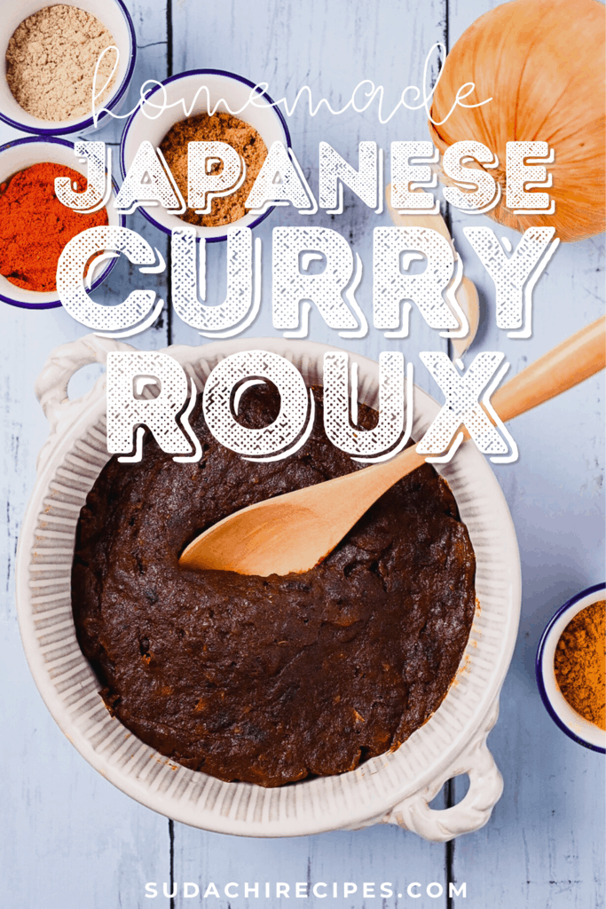 Homemade Japanese curry roux in a white dish with spices and onion on a blue wood effect background
