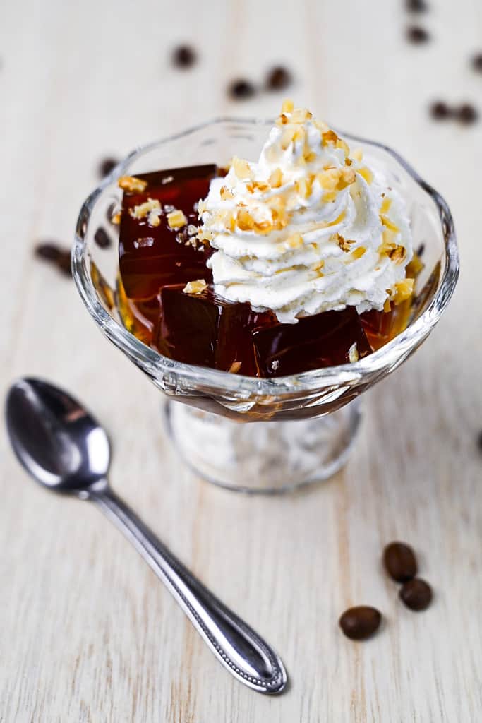 Japanese coffee served in a glass dish with whipped cream and chopped walnuts