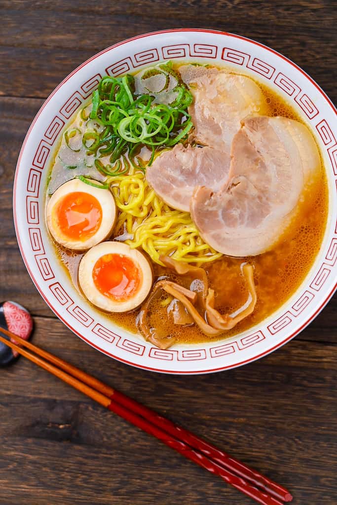 Two halves of ramen egg in a bowl of miso ramen