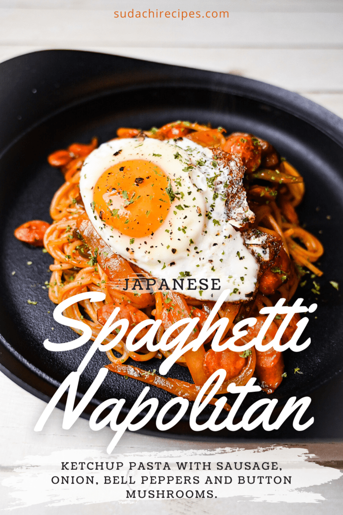 Spaghetti Napolitan (ketchup pasta) on a black plate topped with a fried egg