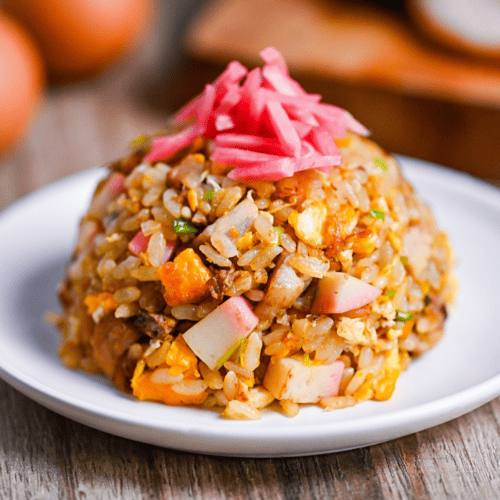 Ramen restaurant-style chahan (fried rice) shaped into a dome and served on a white plate topped with benishoga