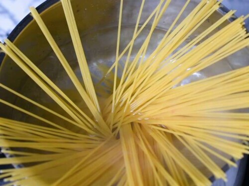 adding spaghetti to boiling water