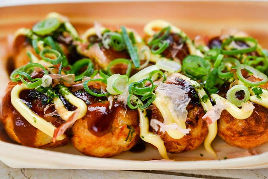 Takoyaki in a bamboo boat container side view