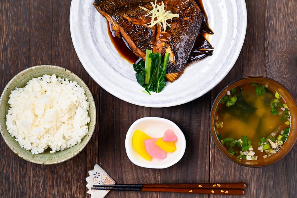 Sakana no nitsuke Japanese simmered fish in a teishoku set with miso soup, pickles and rice