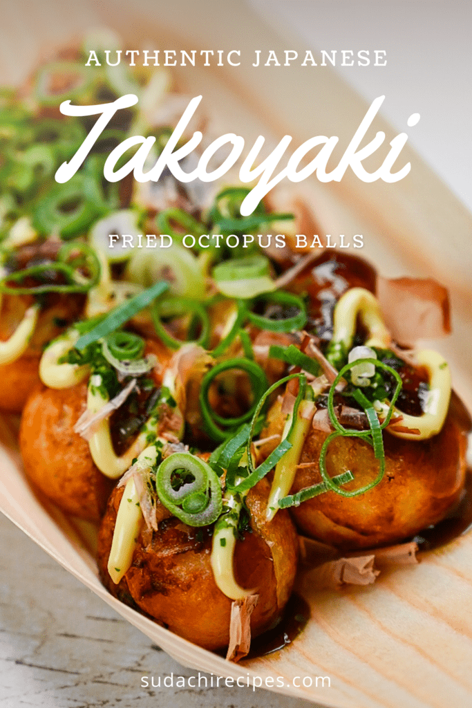 Japanese Takoyaki Fried Octopus Balls in a bamboo boat topped with spring onion, takoyaki sauce and mayonnaise