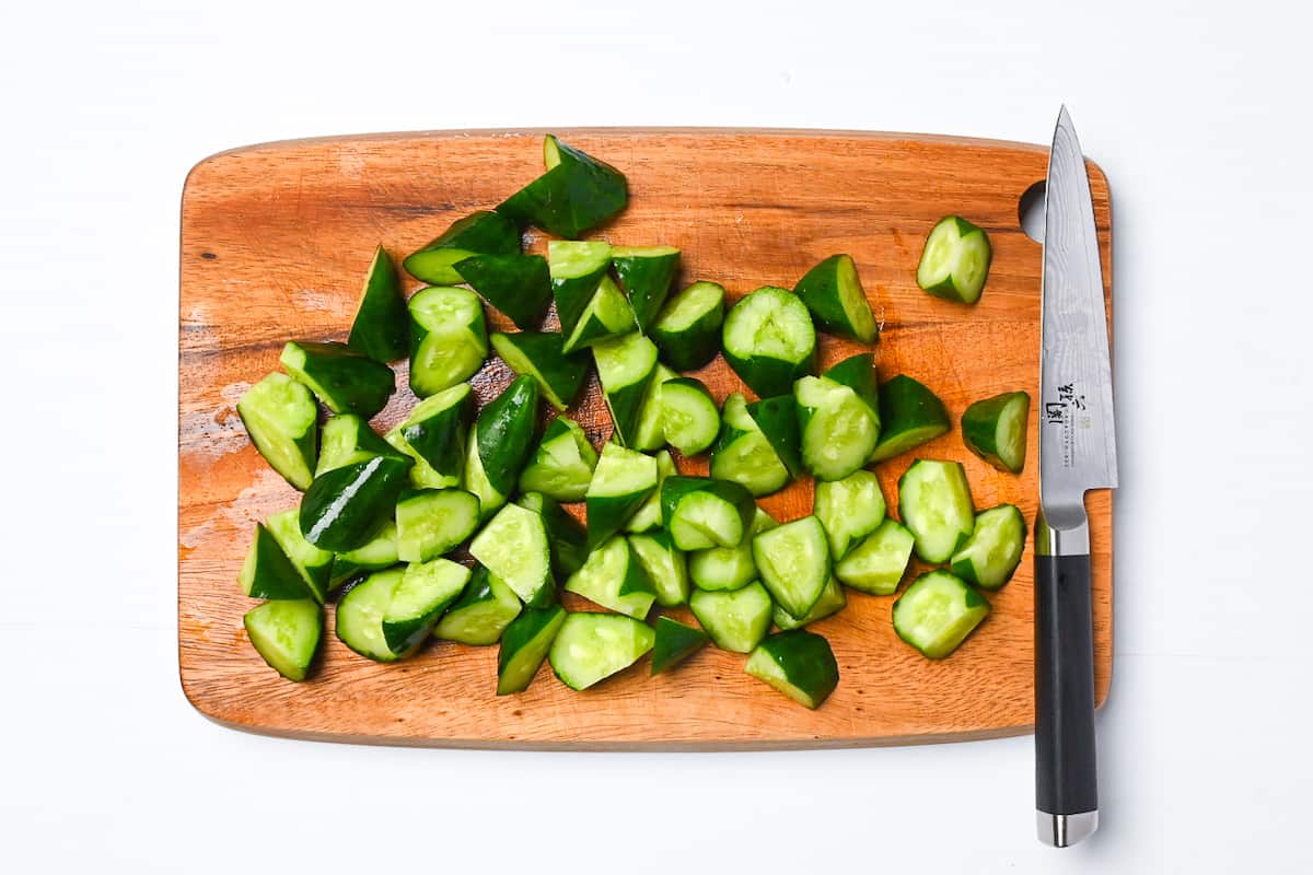 Cut cucumber on wooden chopping board