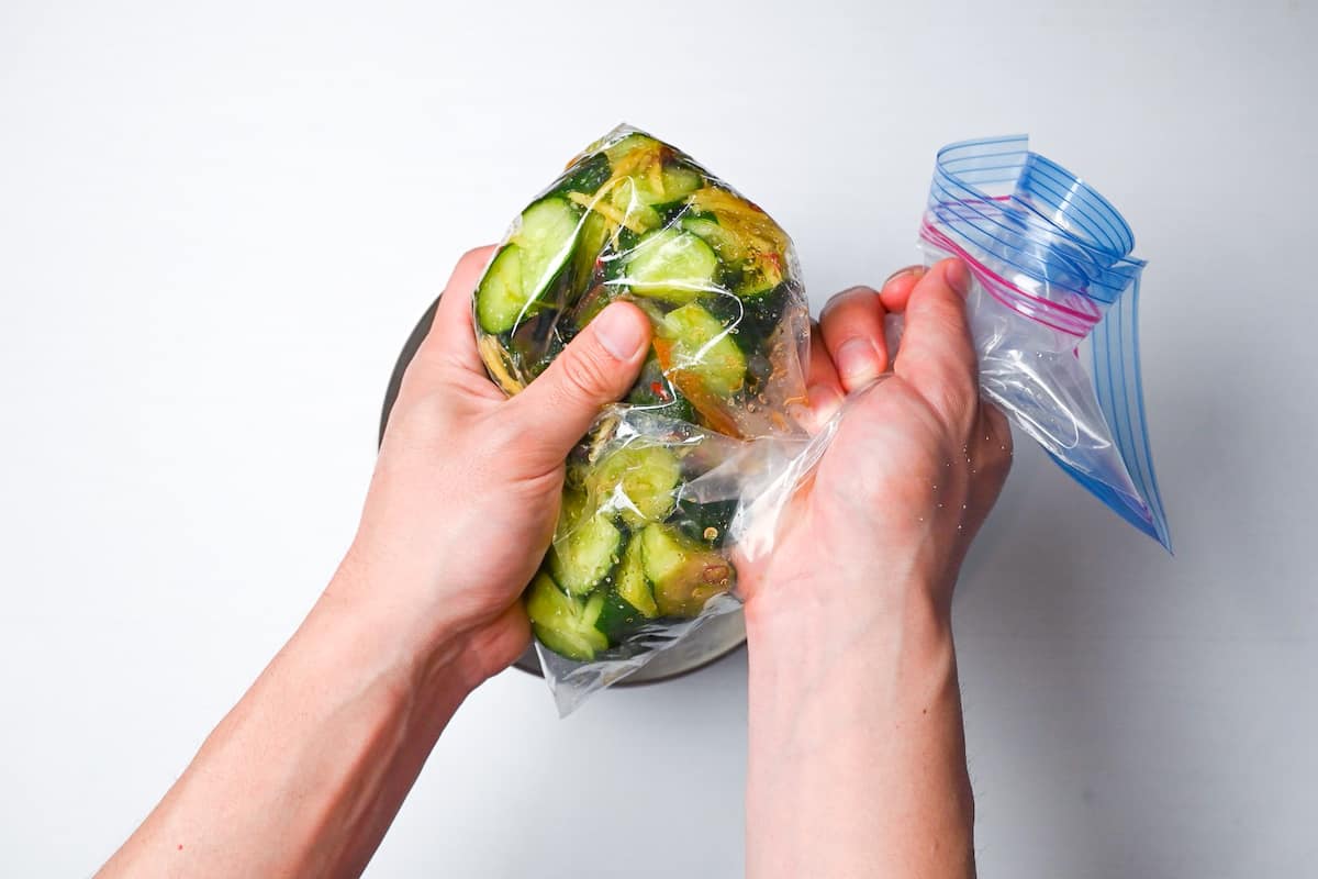 Massaging cucumber pickles in a ziplock bag