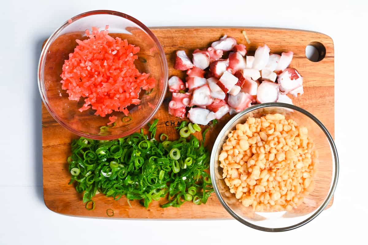 Takoyaki ingredients: finely diced benishoga, bitesize pieces of boiled octopus, chopped spring onion and a bowl of tenkasu (tempura bits)