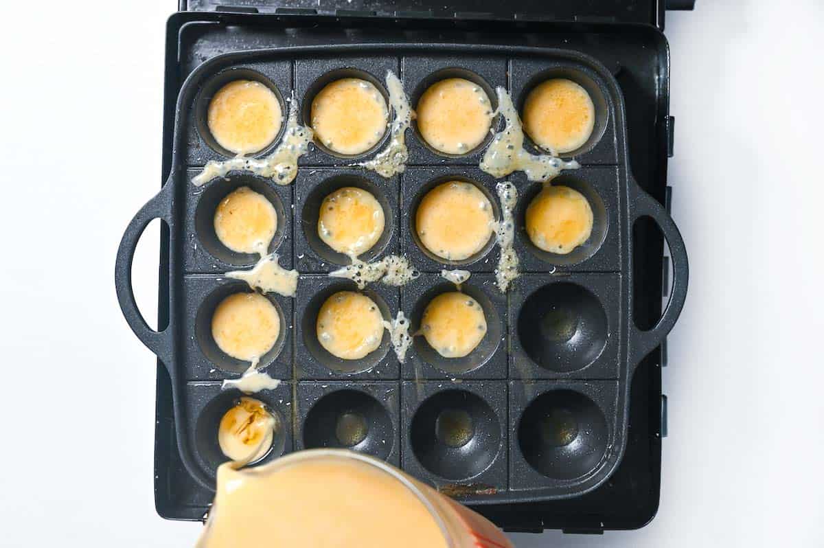 Pouring batter into the takoyaki pan