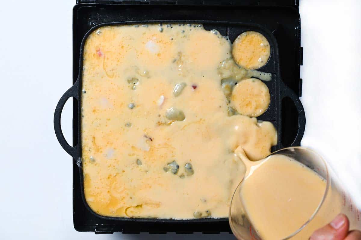 Pouring batter over the takoyaki pan