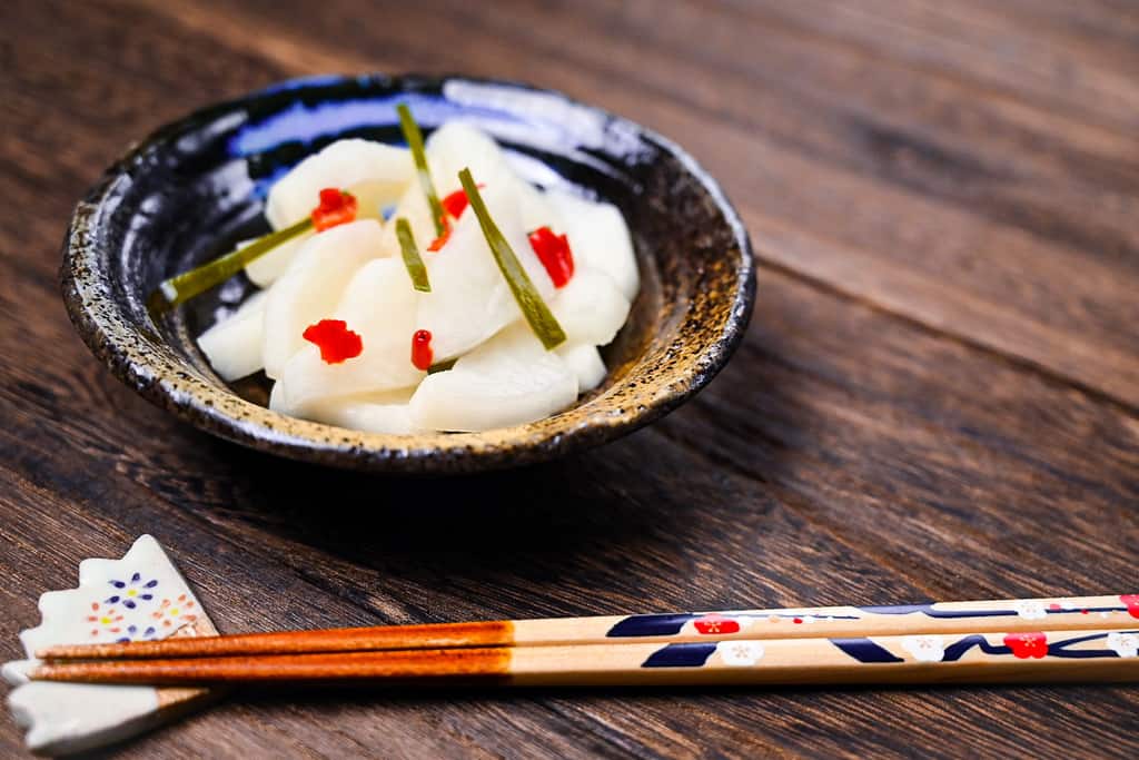 Bettarazake daikon pickles next to wooden chopsticks