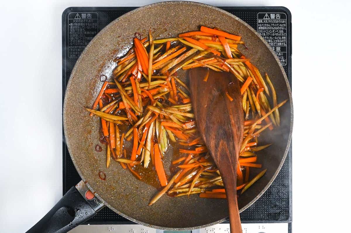 stir frying burdock root and carrot in kinpira gobo sauce