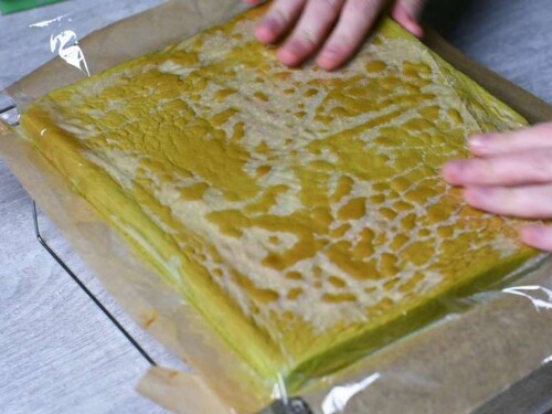 Covering roll cake with plastic wrap