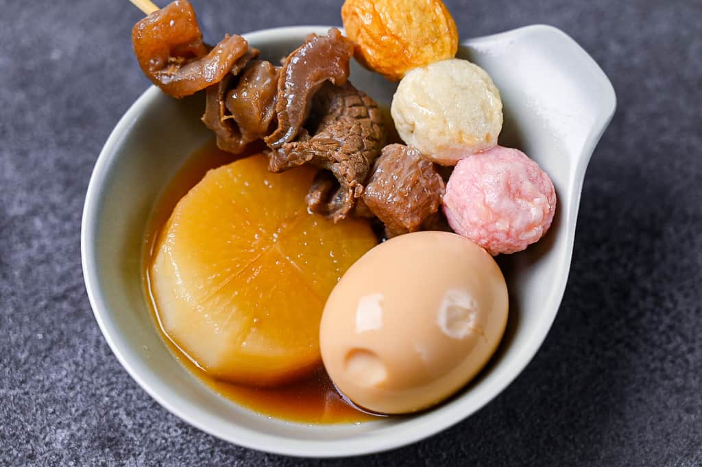 A small dish of oden egg, daikon, gyusuji and fishballs