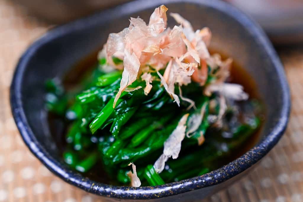 Spinach ohitashi salad topped with bonito flakes