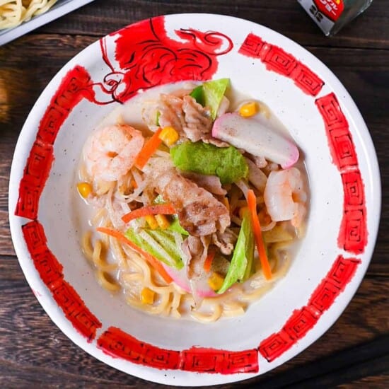 Ringer Hut Style Nagasaki Champon served in a white and red ramen bowl made with pork, shrimps and vegetables in a rich milky broth