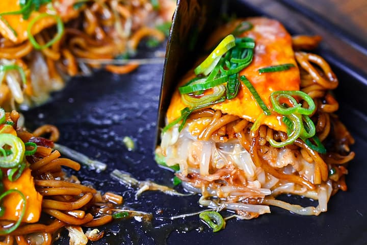 Using a spatula to divide Hiroshima style okonomiyaki