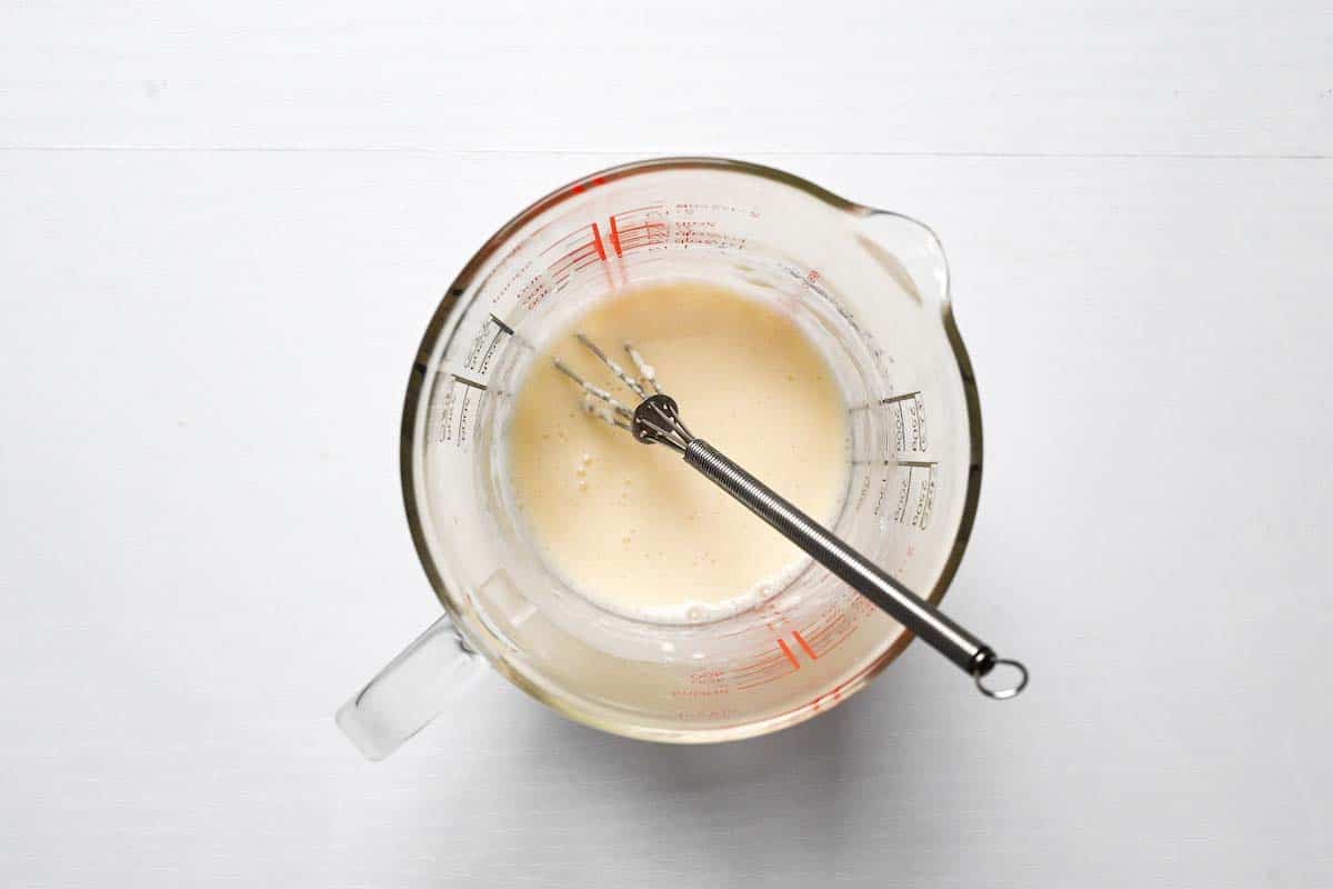 Hiroshima style okonomiyaki batter whisked in a pyrex jug