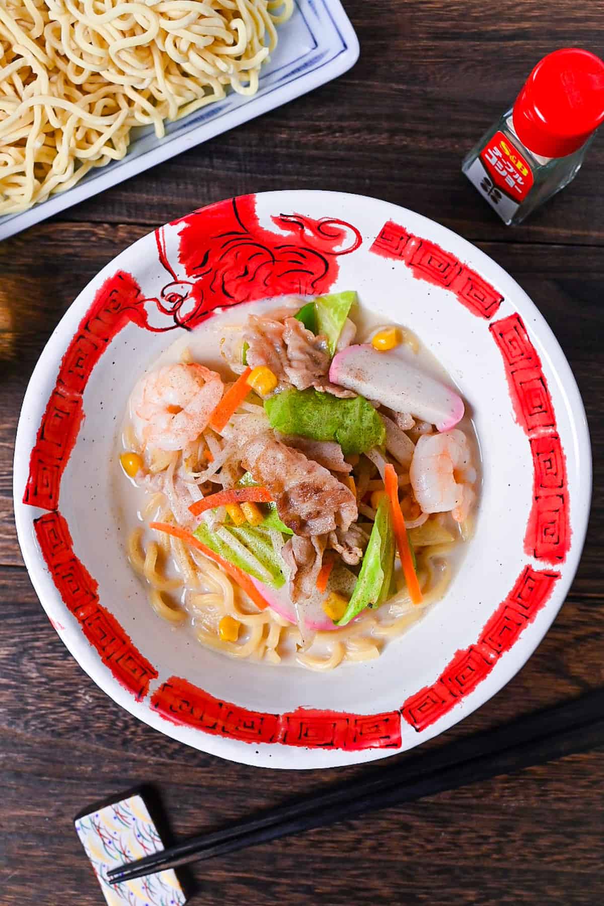 Ringer Hut Style Nagasaki Champon served in a white and red ramen bowl made with pork, shrimps and vegetables in a rich milky broth