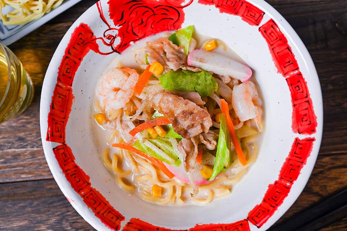 Ringer Hut Style Nagasaki Champon served in a white and red ramen bowl made with pork, shrimps and vegetables in a rich milky broth