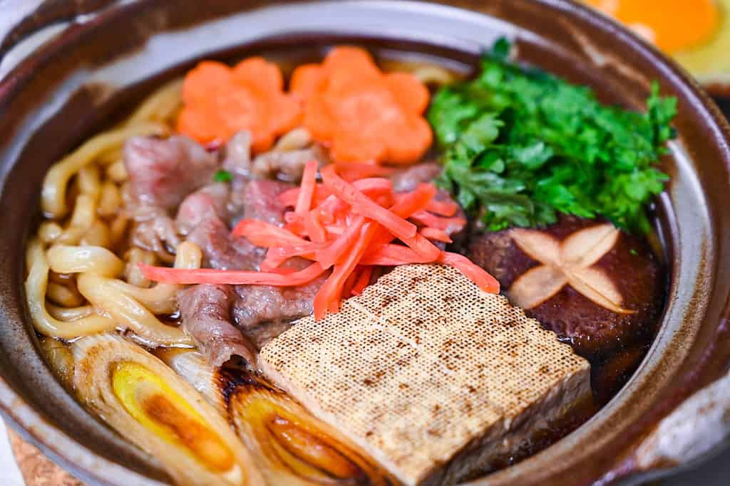 Sukiyaki nabe udon in a brown donabe