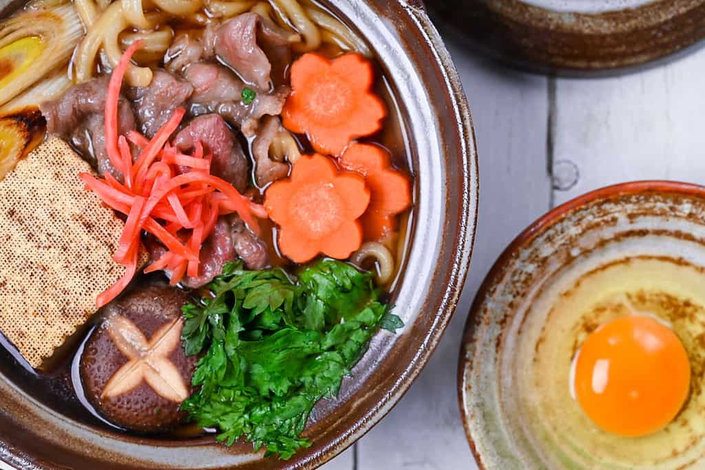 Sukiyaki nabe udon in a brown donabe