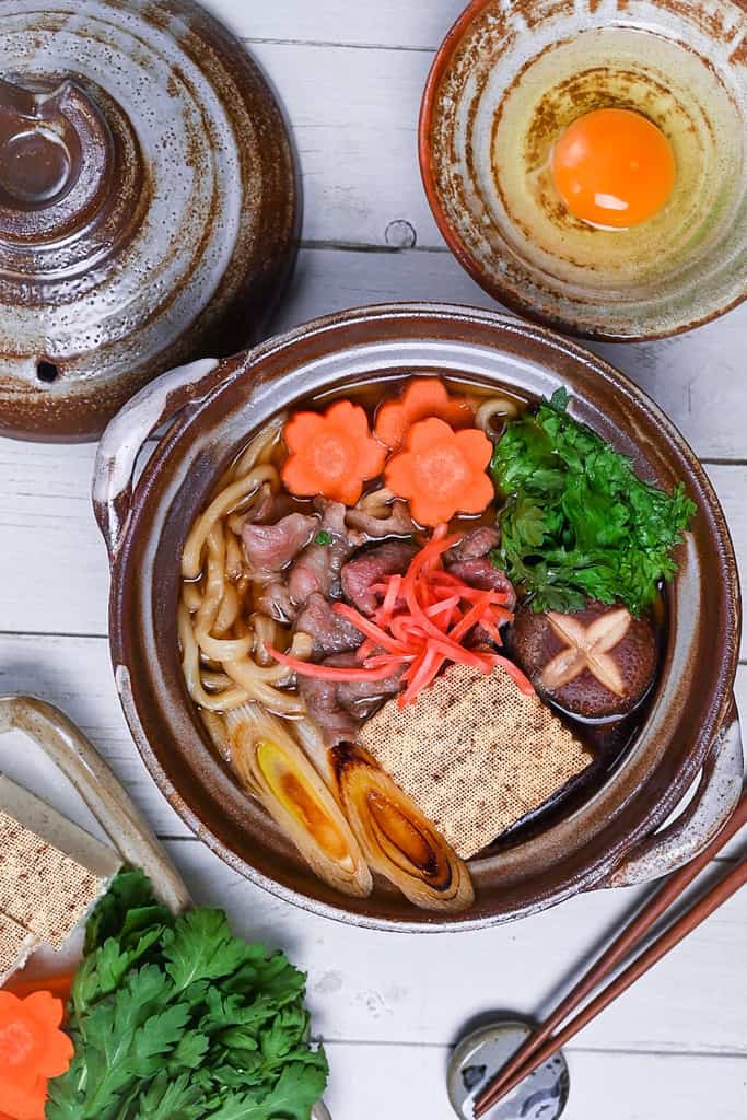 Sukiyaki nabe udon in a brown donabe